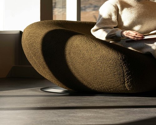 person reading a book in a comfortable room